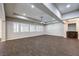 Spacious living area featuring wood-look tile, recessed lighting, and ample windows with white shutters at 8351 Agave Bloom St, Las Vegas, NV 89131