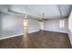 Bright living room with wood-look floors and plantation shutters, leading to another room at 8351 Agave Bloom St, Las Vegas, NV 89131