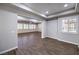 Bright and airy living room with wood-look flooring, tray ceiling, and many windows with shutters at 8351 Agave Bloom St, Las Vegas, NV 89131