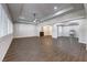 Open-concept living room featuring wood-look tile floors, natural light and a decorative barn door feature at 8351 Agave Bloom St, Las Vegas, NV 89131