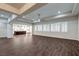 Expansive living room with wood-look tile floors and lots of natural light from the shuttered windows at 8351 Agave Bloom St, Las Vegas, NV 89131