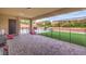 Covered patio with a brick-paved floor and a fenced yard beyond, offering a seamless transition to outdoor living at 8351 Agave Bloom St, Las Vegas, NV 89131