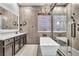 Spa-like bathroom with a large soaking tub and walk-in shower at 120 Emerald Dunes Cir, Henderson, NV 89052