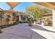 Backyard oasis with fire pit, seating area, and shade sail at 120 Emerald Dunes Cir, Henderson, NV 89052