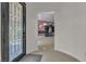 Elegant entryway with glass door and view of living room at 120 Emerald Dunes Cir, Henderson, NV 89052