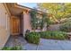 Inviting front entry with landscaping and a wooden door at 120 Emerald Dunes Cir, Henderson, NV 89052
