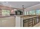 Island kitchen with granite countertops and stainless steel appliances at 120 Emerald Dunes Cir, Henderson, NV 89052