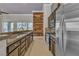 Open concept kitchen with granite countertops and wood wall at 120 Emerald Dunes Cir, Henderson, NV 89052