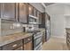 Modern kitchen with stainless steel appliances and granite countertops at 120 Emerald Dunes Cir, Henderson, NV 89052