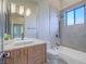 Modern bathroom with a floating vanity, walk-in shower, and bathtub at 309 Rosegate Ave, Henderson, NV 89052