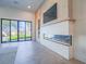 Living room with modern fireplace and sliding glass doors to backyard at 309 Rosegate Ave, Henderson, NV 89052