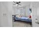 Comfortable bedroom featuring neutral carpet, fan, a mounted TV, and a cozy bed with a cuddly teddy bear at 4343 Countryside Glen Ct, North Las Vegas, NV 89084