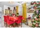 Dining area with red table, chairs, and a Christmas tree at 4343 Countryside Glen Ct, North Las Vegas, NV 89084