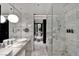 Elegant bathroom featuring marble finishes, double sinks, and a shower at 4381 W Flamingo Rd # 9301, Las Vegas, NV 89103