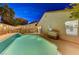 Inviting backyard oasis featuring a sparkling pool, patio, and string lights at 6341 W Haleh Ave, Las Vegas, NV 89141