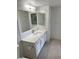 Bright bathroom with a large mirror, modern vanity and a toilet at 7255 W Sunset Rd # 2046, Las Vegas, NV 89113