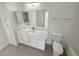 Bright bathroom featuring a large mirror, white cabinets, quartz countertop, and modern fixtures at 7255 W Sunset Rd # 2046, Las Vegas, NV 89113