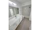 Clean, bright bathroom featuring quartz countertops, white cabinets, a shower-tub combo, and neutral flooring at 7255 W Sunset Rd # 2046, Las Vegas, NV 89113