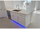 Kitchen island featuring stainless steel sink, modern faucet and white cabinets at 7255 W Sunset Rd # 2046, Las Vegas, NV 89113