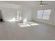 Bright living room featuring wood-style flooring, modern ceiling fan, and natural light from a large window at 7255 W Sunset Rd # 2046, Las Vegas, NV 89113