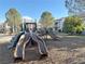 Community playground area with slides, climbing structures, and a soft ground covering for play at 7255 W Sunset Rd # 2046, Las Vegas, NV 89113