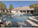 Community pool and lounge area with abundant seating, trees and sun for relaxation and socializing at 7255 W Sunset Rd # 2046, Las Vegas, NV 89113