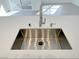 Close-up of stainless steel kitchen sink and modern faucet, atop white countertop at 7255 W Sunset Rd # 2046, Las Vegas, NV 89113