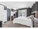 Relaxing bedroom featuring neutral colors, slider to backyard, and carpeted floors at 8253 Abercrombe Way, Las Vegas, NV 89145