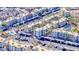 Aerial view of condo community featuring multiple pools, covered parking and mature palm trees at 2056 Mesquite Ln # 303, Laughlin, NV 89029