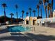 Relaxing community pool and spa area with a low fence, a building for changing, and palm trees at 2056 Mesquite Ln # 303, Laughlin, NV 89029