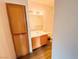 Compact bathroom featuring wood-look floors, wooden vanity and medicine cabinet at 2100 Black Island St # 101, Las Vegas, NV 89128