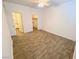 Spacious bedroom with wood-look tile floors, walk-in closet, and neutral walls at 2100 Black Island St # 101, Las Vegas, NV 89128