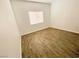 Neutral bedroom featuring bright natural light and wood-look tile flooring at 2100 Black Island St # 101, Las Vegas, NV 89128
