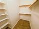 Walk-in closet with built-in shelving and wood-look tile flooring at 2100 Black Island St # 101, Las Vegas, NV 89128