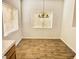 Bright dining room with wood-look tile flooring and chandelier at 2100 Black Island St # 101, Las Vegas, NV 89128