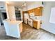 Galley kitchen with wood cabinets, white appliances, and tile floors at 2100 Black Island St # 101, Las Vegas, NV 89128