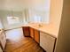 Cozy kitchen area featuring wood-look flooring and dishwasher adjacent to the living space at 2100 Black Island St # 101, Las Vegas, NV 89128