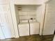 Convenient laundry area equipped with a white washer and dryer, and open shelving at 2100 Black Island St # 101, Las Vegas, NV 89128