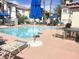 Community pool area with lounge chairs and umbrellas at 2100 Black Island St # 101, Las Vegas, NV 89128