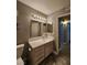 Bright bathroom featuring a vanity, toilet, mirrors, and tile flooring at 2725 S Nellis Blvd # 1105, Las Vegas, NV 89121