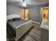 Bedroom with hardwood flooring and dresser featuring access to the bathroom at 2725 S Nellis Blvd # 1105, Las Vegas, NV 89121