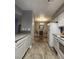 Kitchen to dining room features tiled floor and dining room with wood floors at 2725 S Nellis Blvd # 1105, Las Vegas, NV 89121