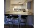 Bright kitchen features counter seating, neutral countertop, and white cabinets at 2725 S Nellis Blvd # 1105, Las Vegas, NV 89121