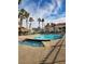 Community pool surrounded by palm trees, lounging area, and a red-tiled roofed structure at 2725 S Nellis Blvd # 1105, Las Vegas, NV 89121