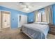 Spacious bedroom with a large bed and blue walls at 5145 Tennis Ct, Las Vegas, NV 89120