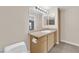 Bathroom with light wood cabinets and a granite countertop at 8000 W Badura Ave # 2106, Las Vegas, NV 89113