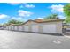 Row of six attached garages with white doors, offering ample parking at 8000 W Badura Ave # 2106, Las Vegas, NV 89113