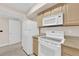 White appliances and light wood cabinets in this kitchen at 8000 W Badura Ave # 2106, Las Vegas, NV 89113