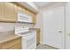 White appliances and light wood cabinets in this galley kitchen at 8000 W Badura Ave # 2106, Las Vegas, NV 89113