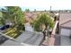 Aerial view of a house with a two-car garage and a nicely landscaped yard with mature trees at 10221 Crystal Arch Ave, Las Vegas, NV 89129